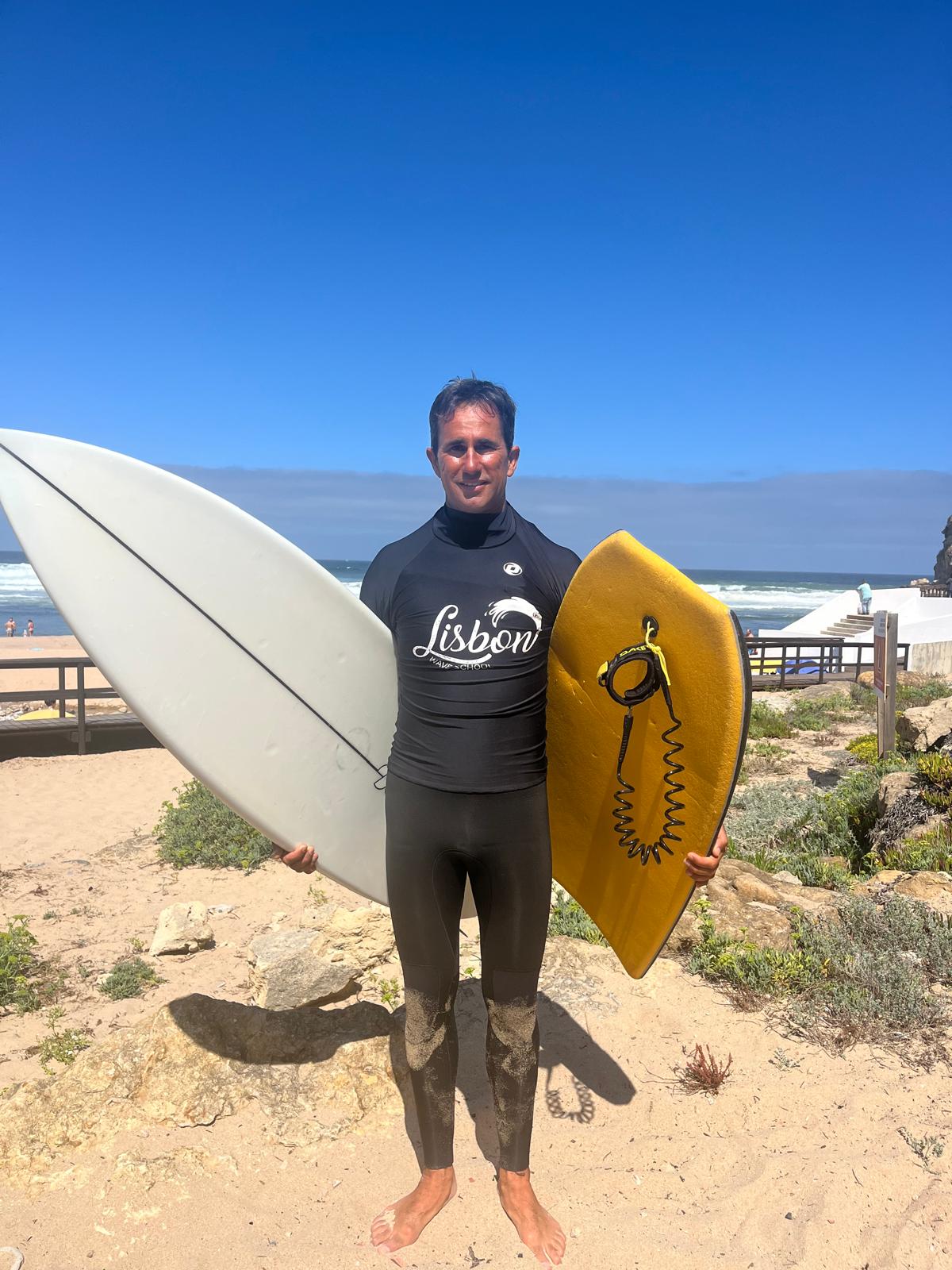 João André, founder of Lisbon Wave School, with his bodyboard above Magoito beach